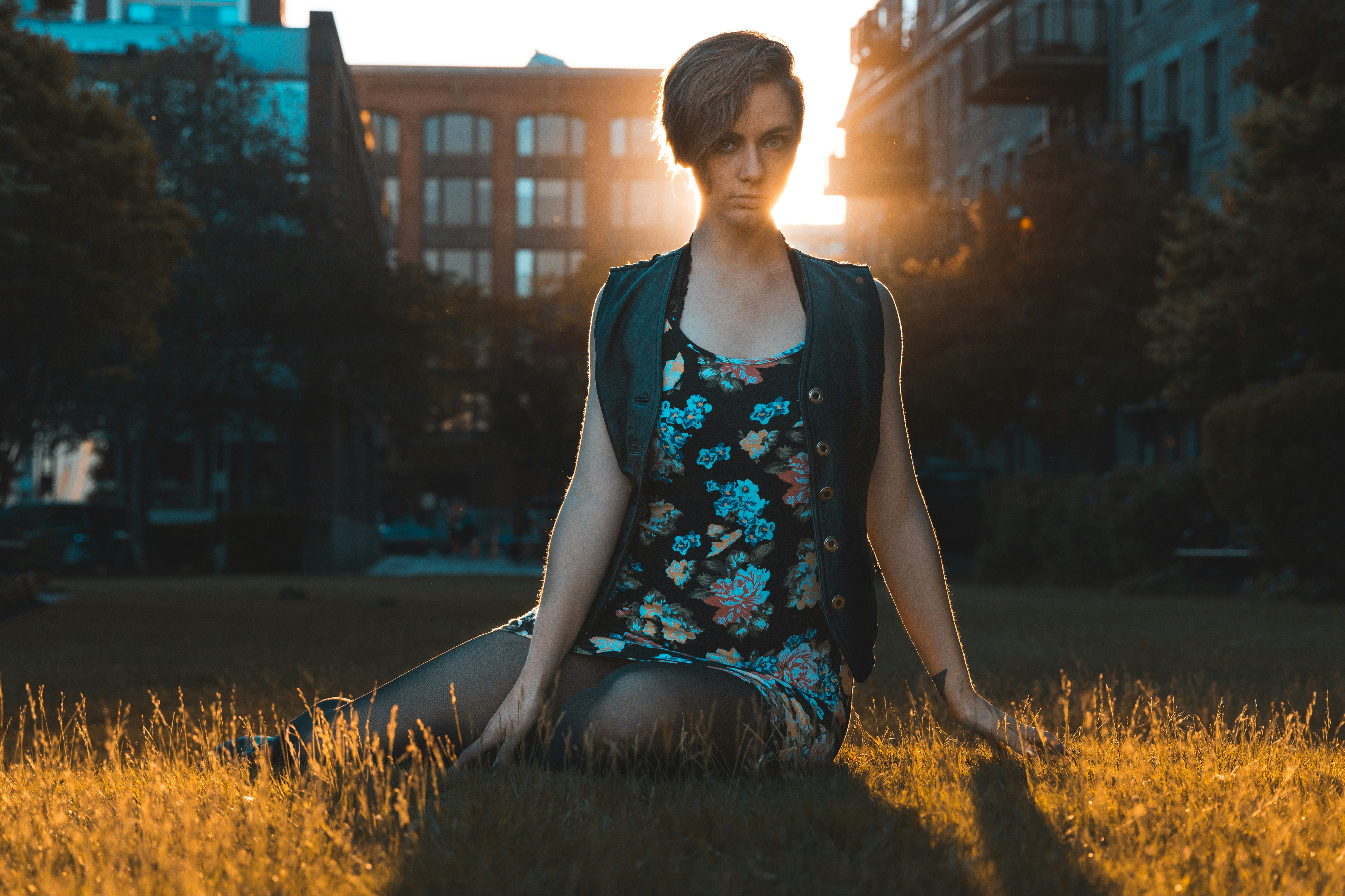 woman sitting on grass field